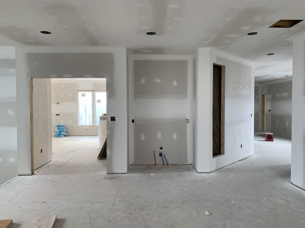 loft with doorway to master on the left and hallway to laundry and exercise on the right. The central nook is going to be a wet bar.