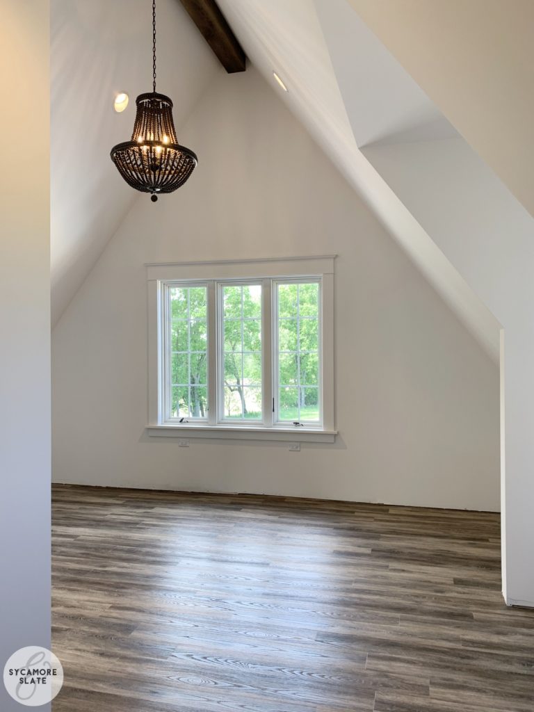 Laundry room with vinyl floors and beaded chandelier