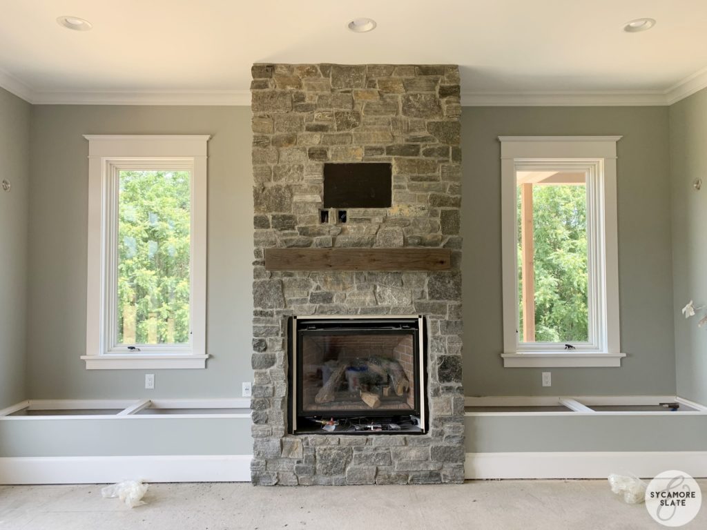 sun room fireplace with flanking window seats