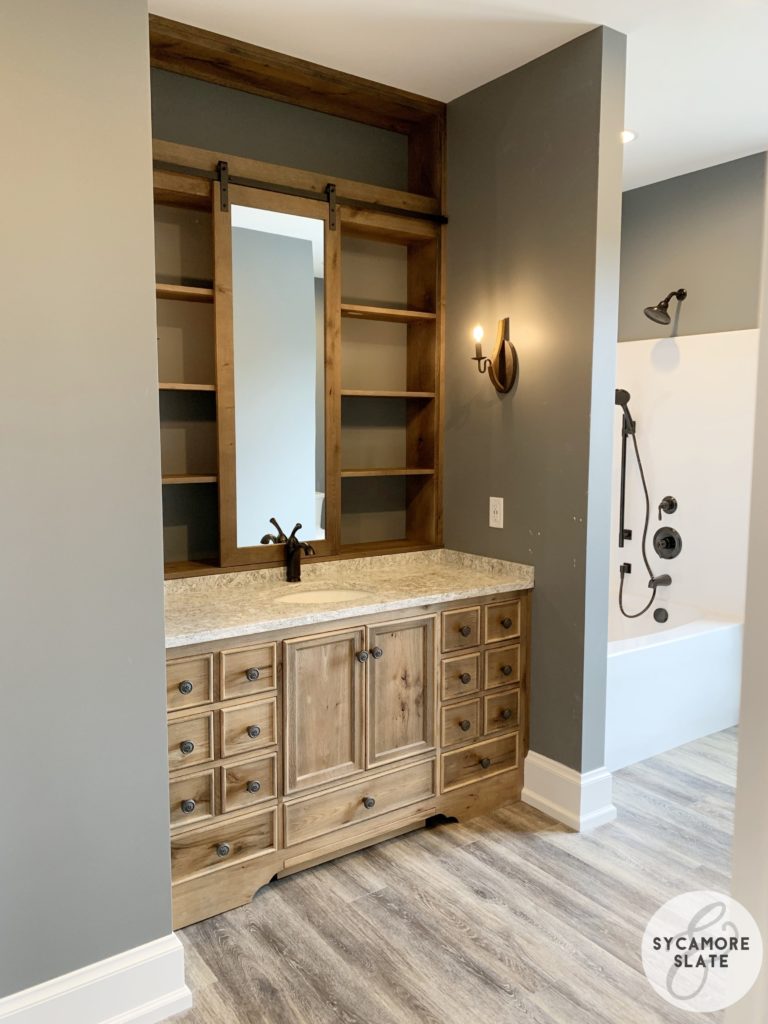 evie's vanity with sliding barn door mirror and bathtub