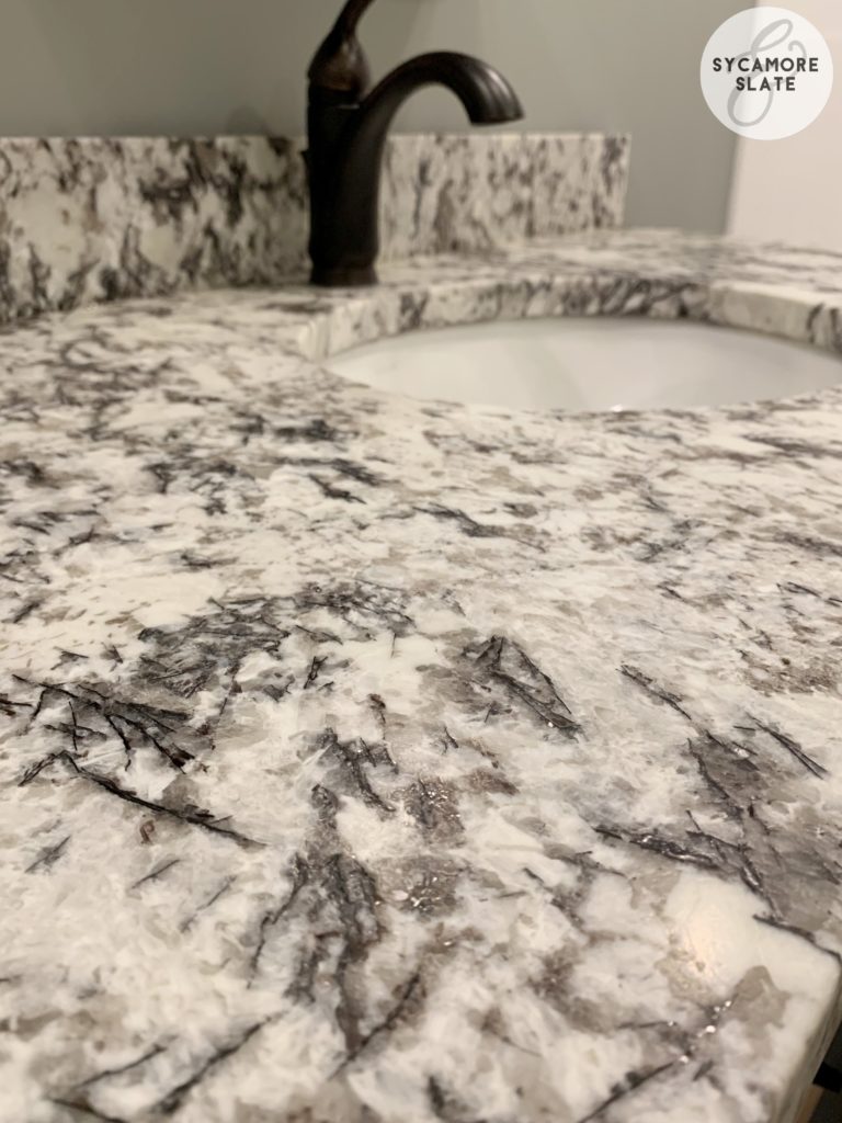 Delicatus White leathered granite on vanity.