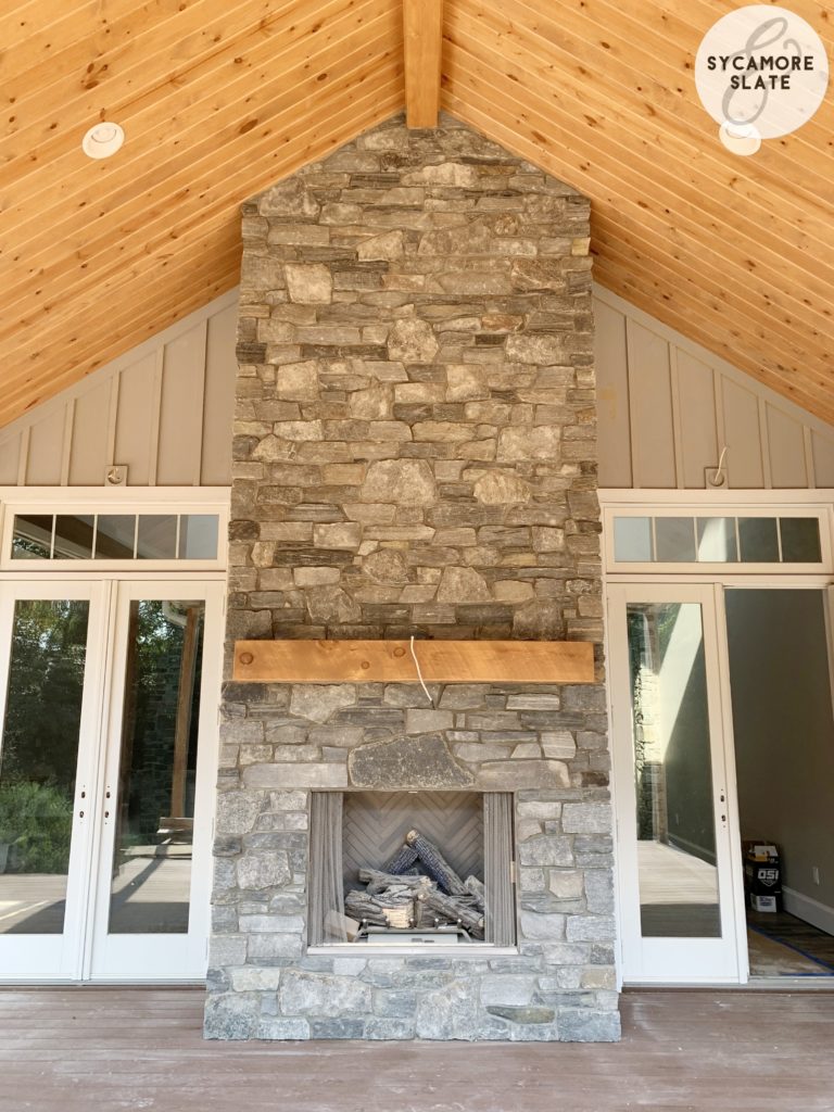 outdoor fireplace on deck with doors to great room on either side