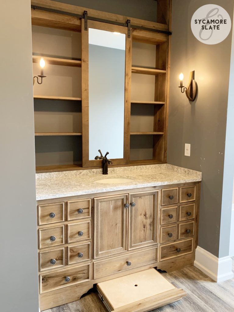 evie's vanity - sliding barn door mirror with open shelving behind it and a hidden drawer / stool combination