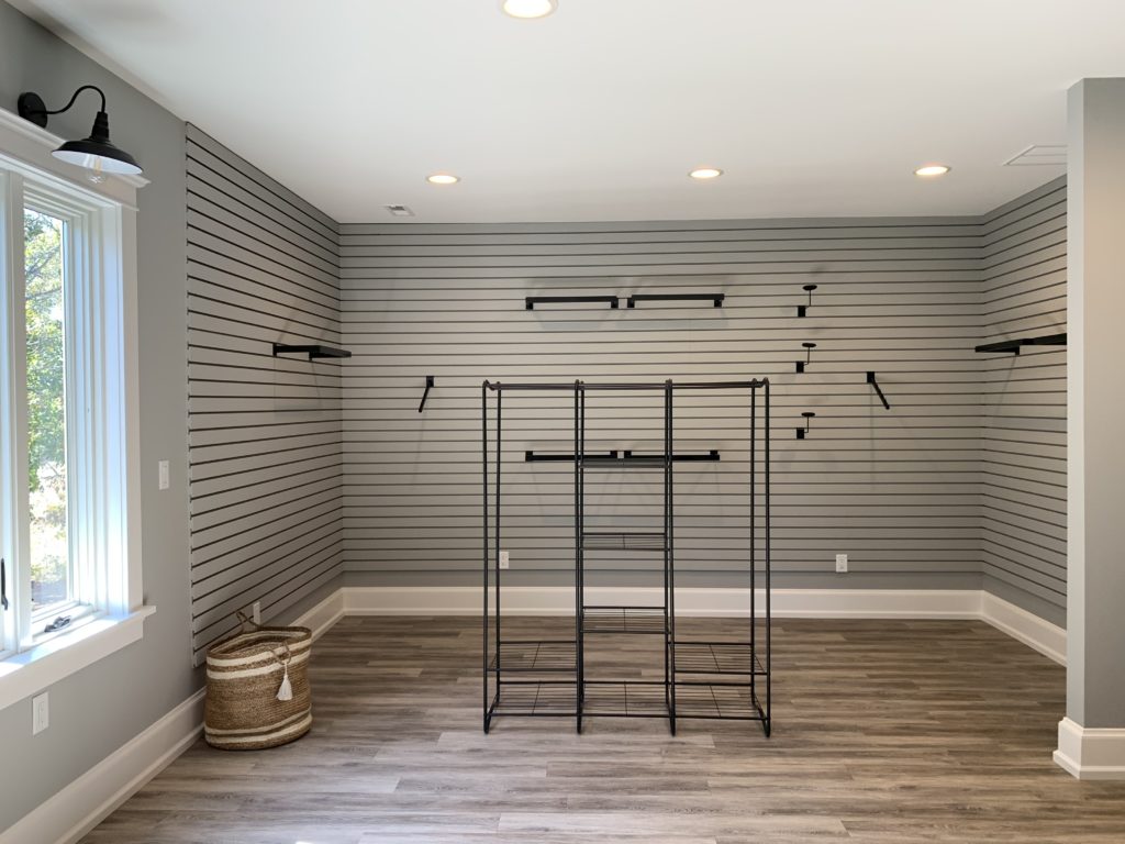 walk in master closet with slat wall