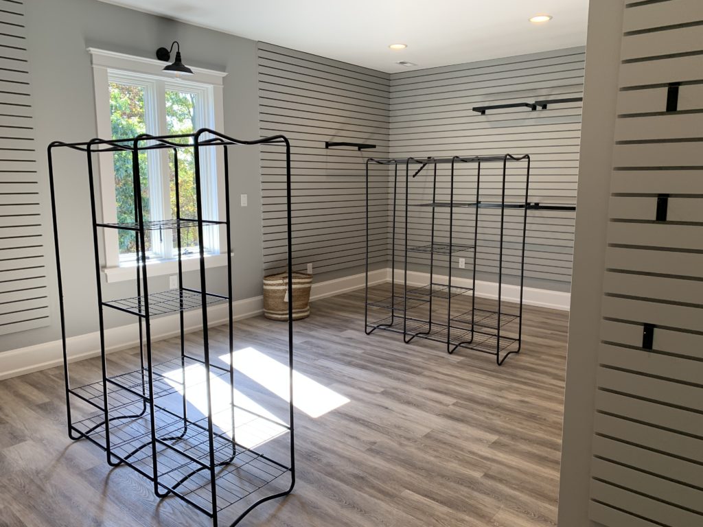 walk in master closet with slat wall