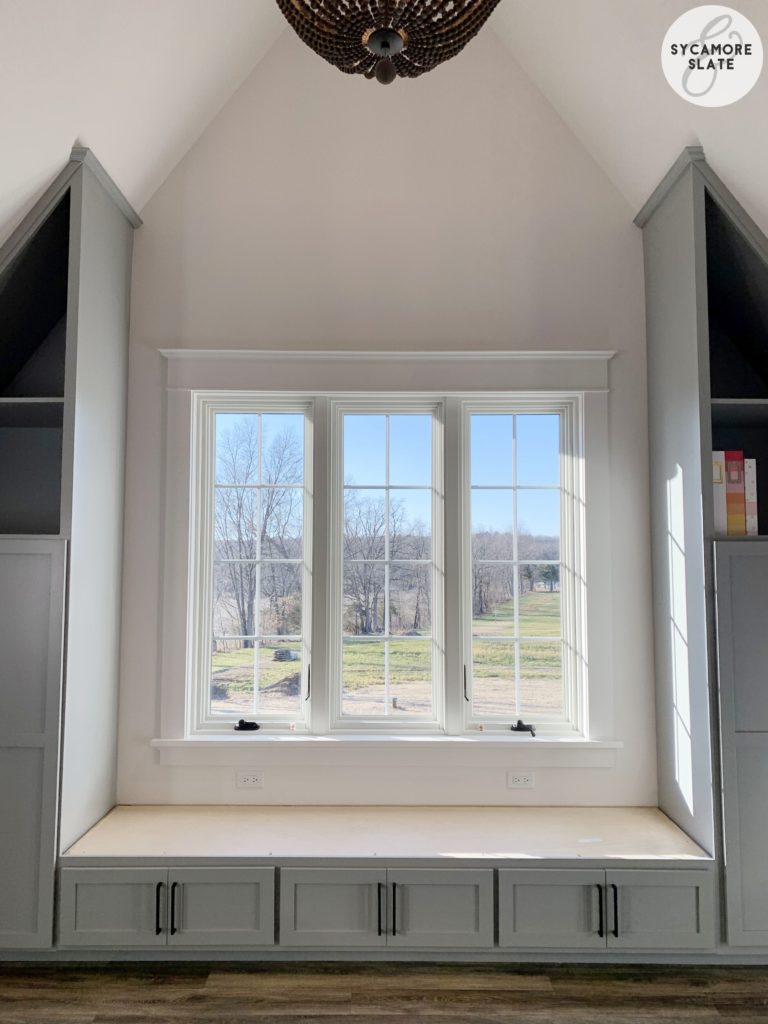 window seat in laundry room with storage